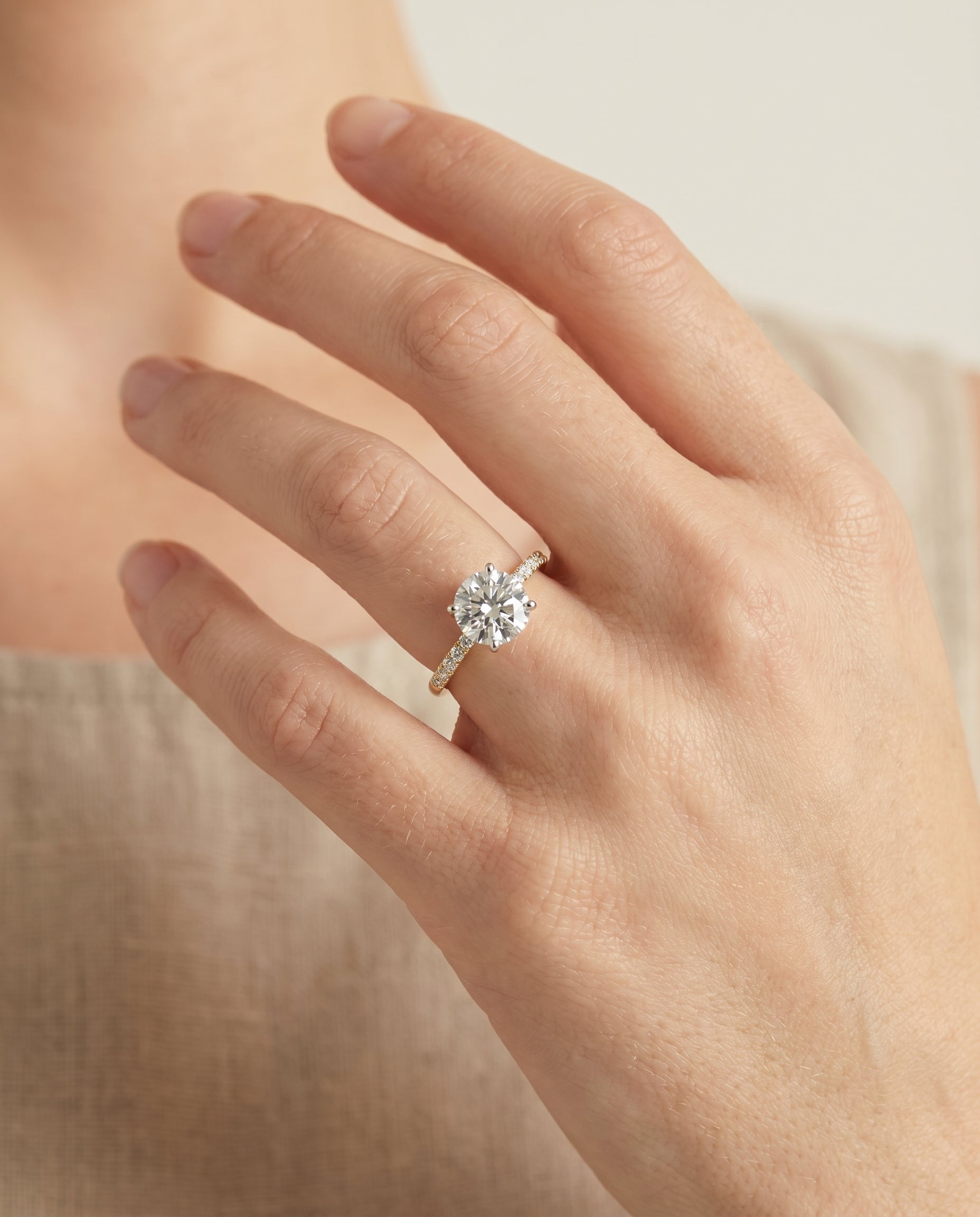 Cherie Select Hidden Halo Pavé Solitaire Round Lab Diamond Engagement Ring in 18K Yellow Gold, shown on hand | RockHer