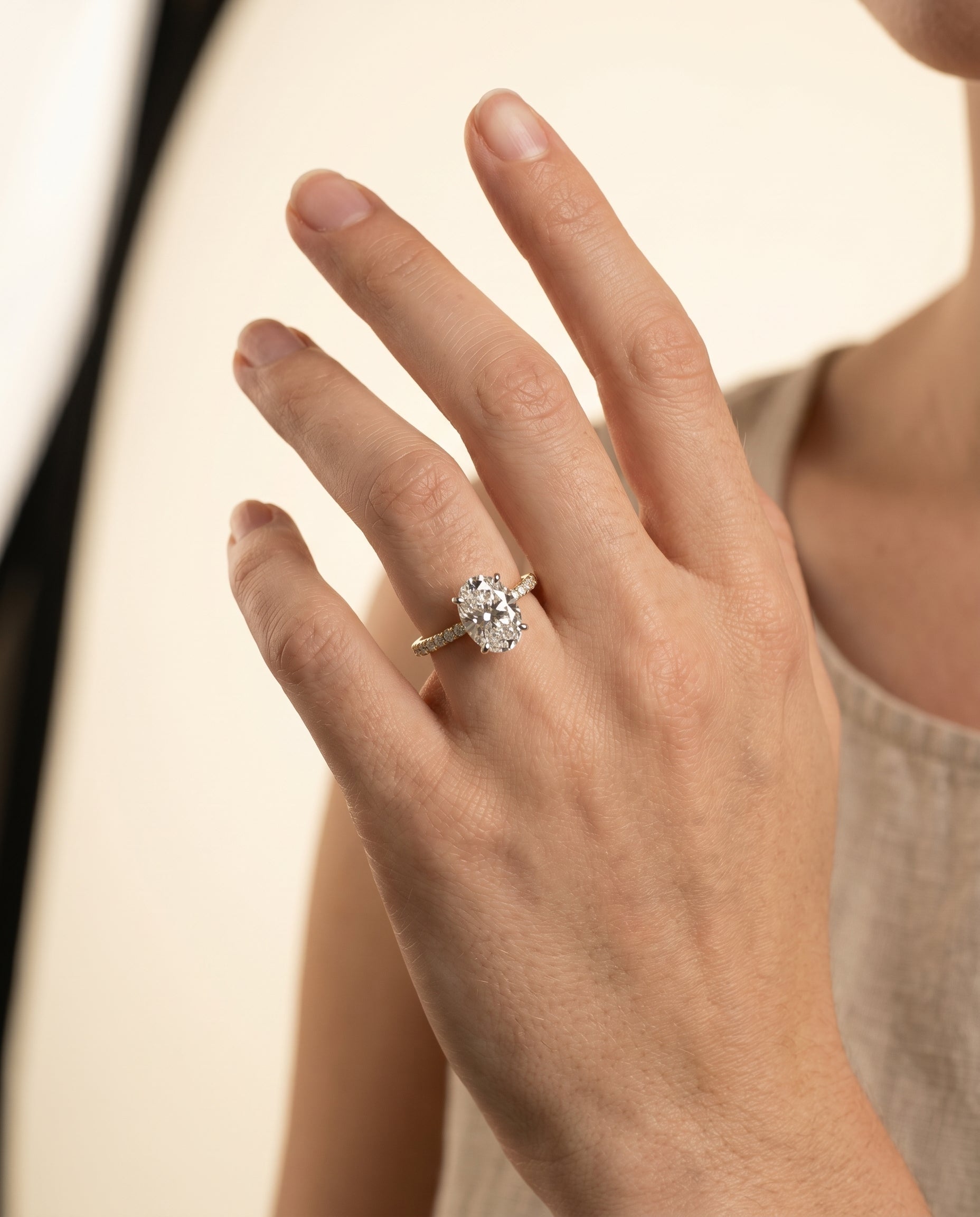 Cherie Select Hidden Halo Pavé Solitaire Oval Lab Diamond Engagement Ring in 18K Yellow Gold, shown on hand | RockHer