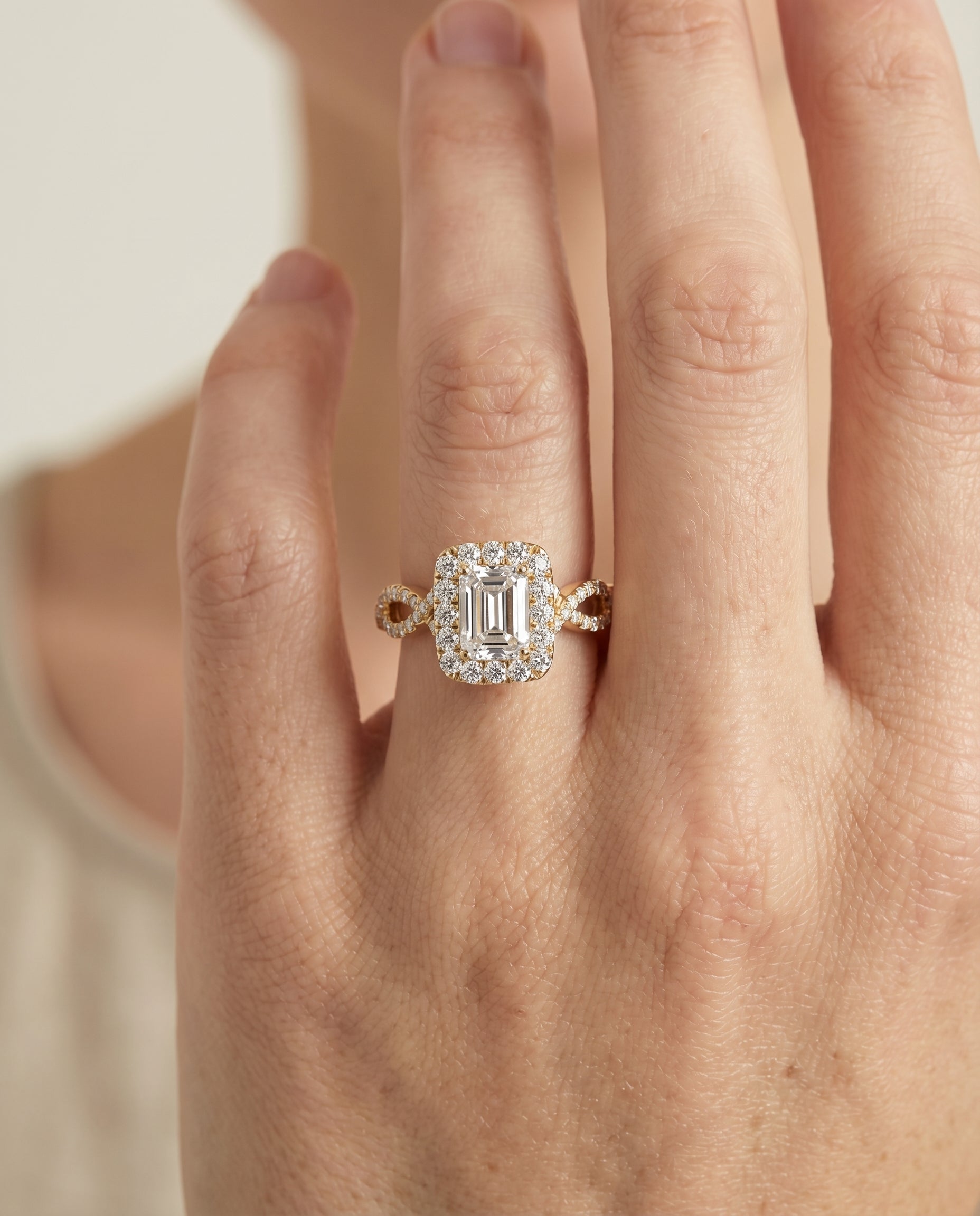 Annie Select Halo Emerald Cut Lab Diamond Engagement Ring in 18K Yellow Gold, shown on hand | RockHer