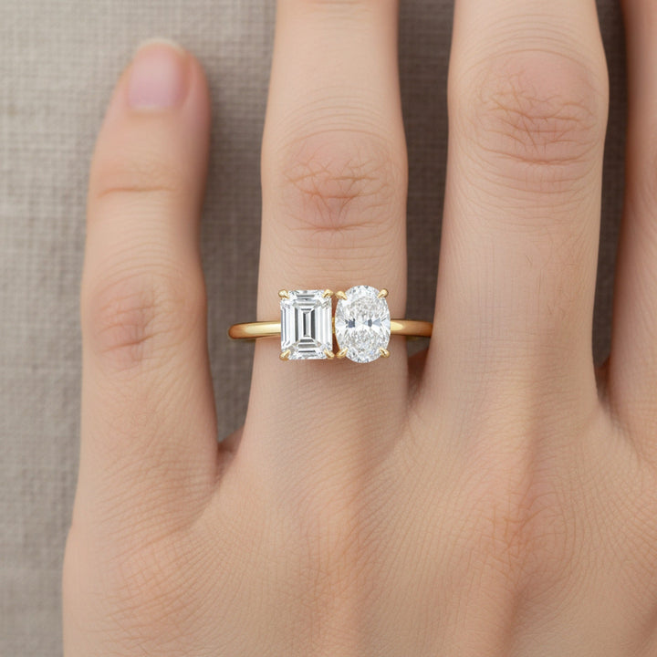 Rihanna Toi et Moi Emerald & Pear engagement ring setting worn on hand