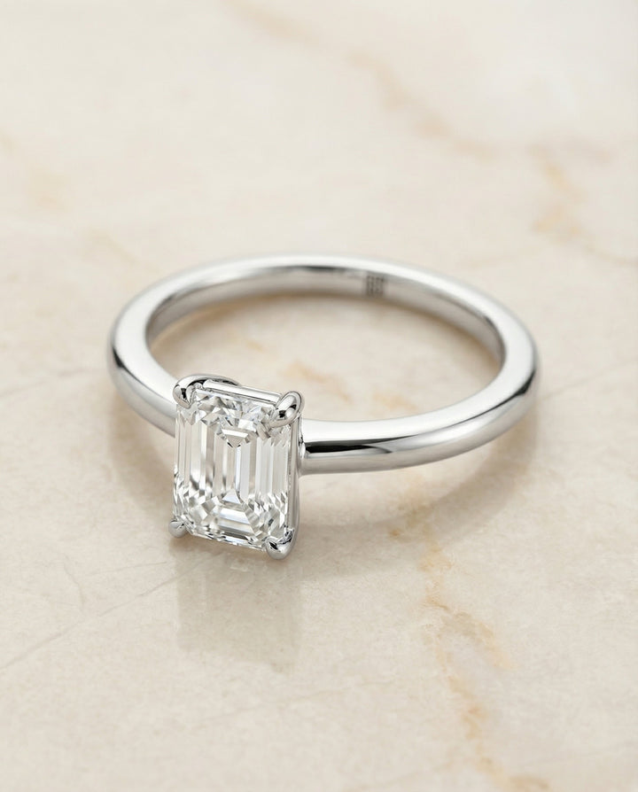 Floria Select round comfort fit claw prong solitaire emerald cut emerald cut ring in Platinum — alt angle — RockHer