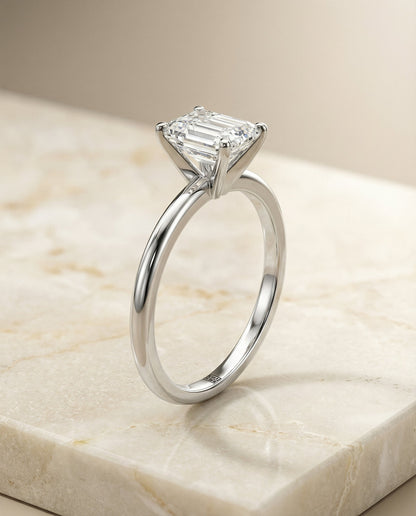 Floria Select Comfort Fit Claw Prong Solitaire Emerald Cut Lab Diamond Engagement Ring in Platinum, front view | RockHer