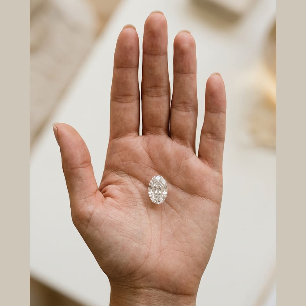 1-1/2 Carat Oval Lab Grown Diamond, true-scale on open palm