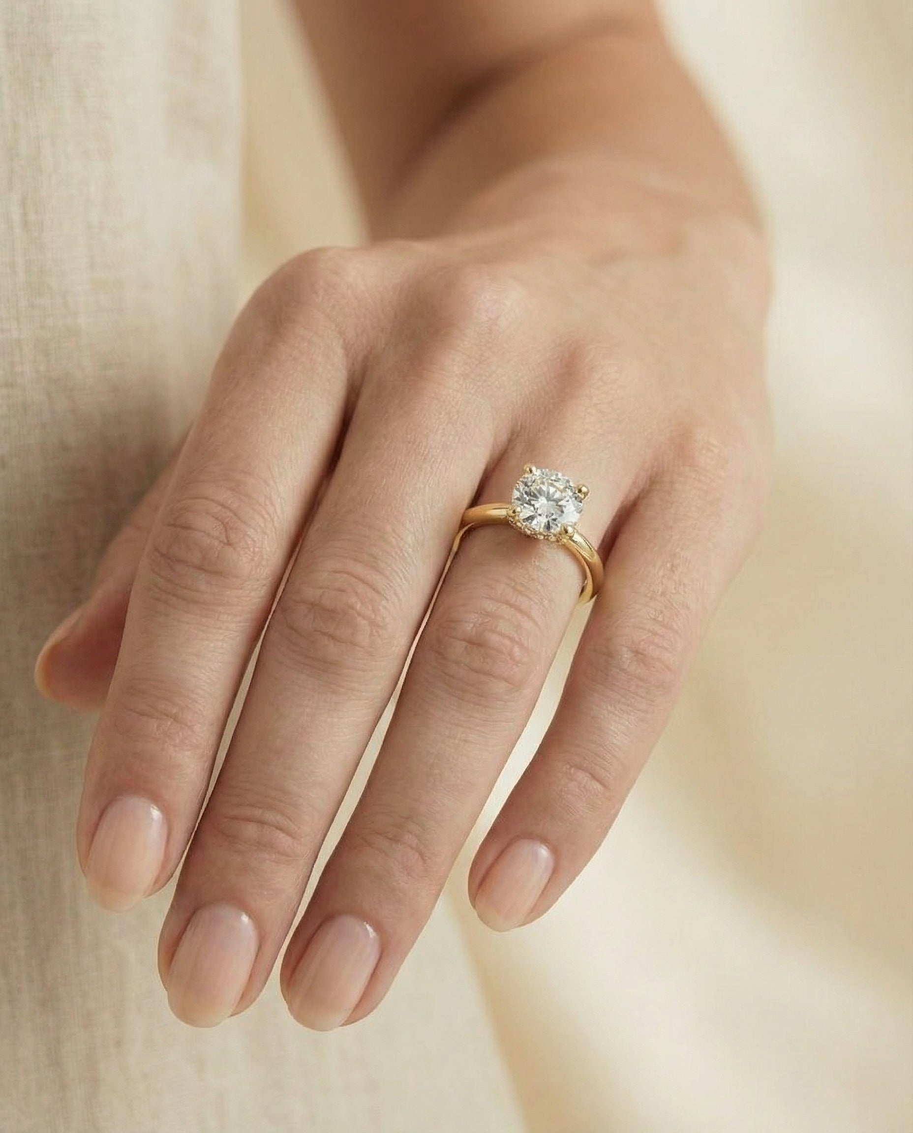 The Lana engagement ring setting in 18K Yellow Gold, secret halo adorned prong solitaire design | RockHer