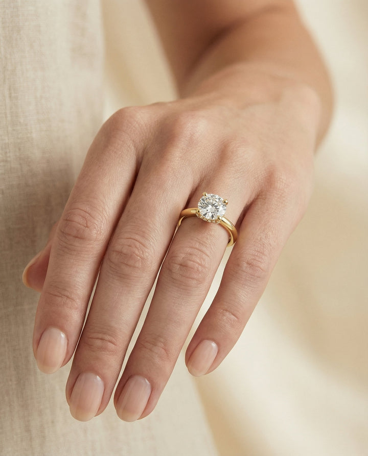 Lana Select secret halo adorned prong solitaire round ring in 14K Yellow Gold — front — RockHer