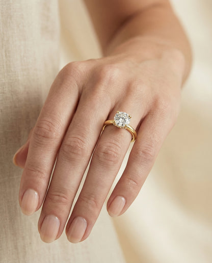 Round Brilliant, Secret Halo Adorned Prong Solitaire, in 18K Yellow Gold – lifestyle shot | RockHer