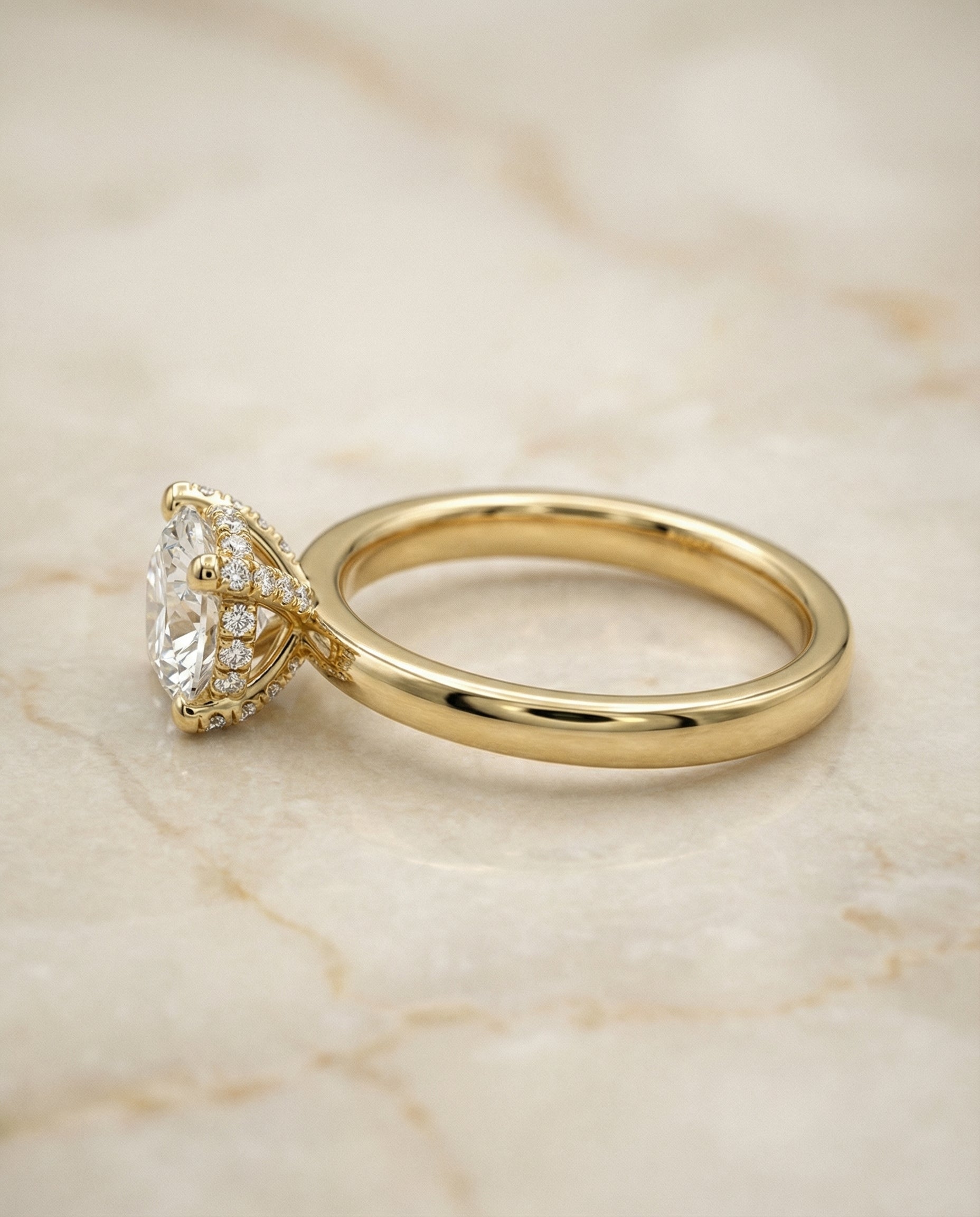 The Lana secret halo adorned prong solitaire engagement ring setting, shown in 18K Yellow Gold | RockHer
