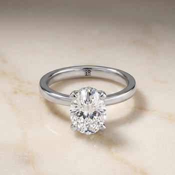 The Lana Secret Halo Adorned Prong Solitaire Oval Engagement Ring Setting in 18K White Gold