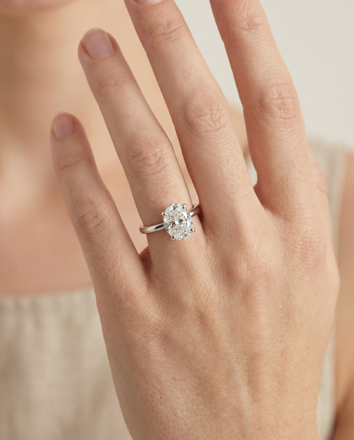 The Lana Secret Halo Adorned Prong Solitaire Oval Engagement Ring Setting in 18K White Gold