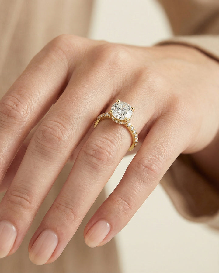Round Brilliant, Secret Halo French Pavé Solitaire, in 18K Yellow Gold – lifestyle shot | RockHer