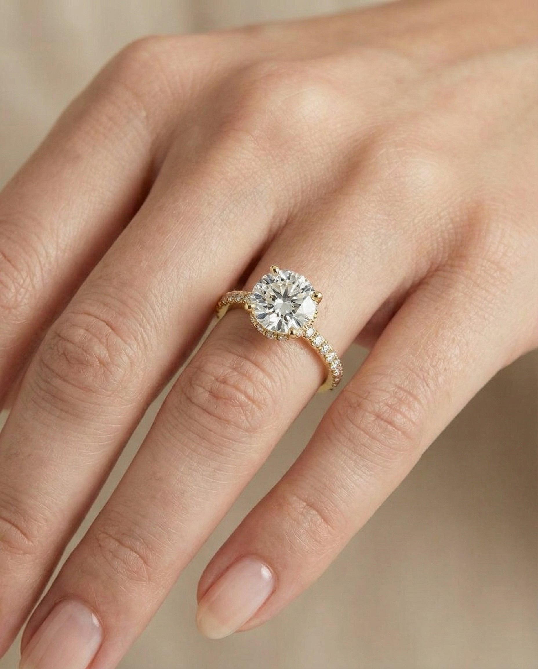Elliott Select Hidden Halo Pavé Round Lab Diamond Engagement Ring in 18K Yellow Gold, shown on hand | RockHer