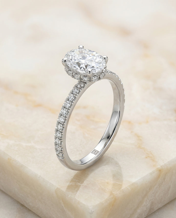 Secret Halo French Pavé Solitaire Oval, in Platinum – angled view | RockHer