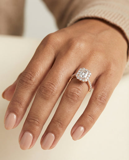 Fiona Select shared prong halo emerald cut emerald cut ring in 14K Rose Gold — on hand angled — RockHer