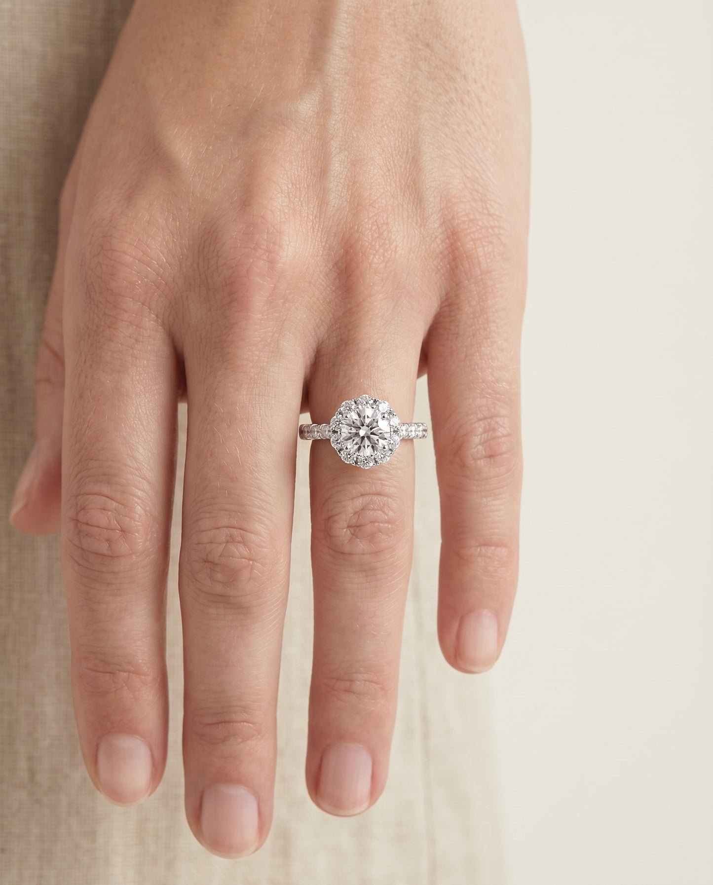Round Brilliant, Shared Prong Halo Linear Band, in 18K White Gold – lifestyle shot | RockHer