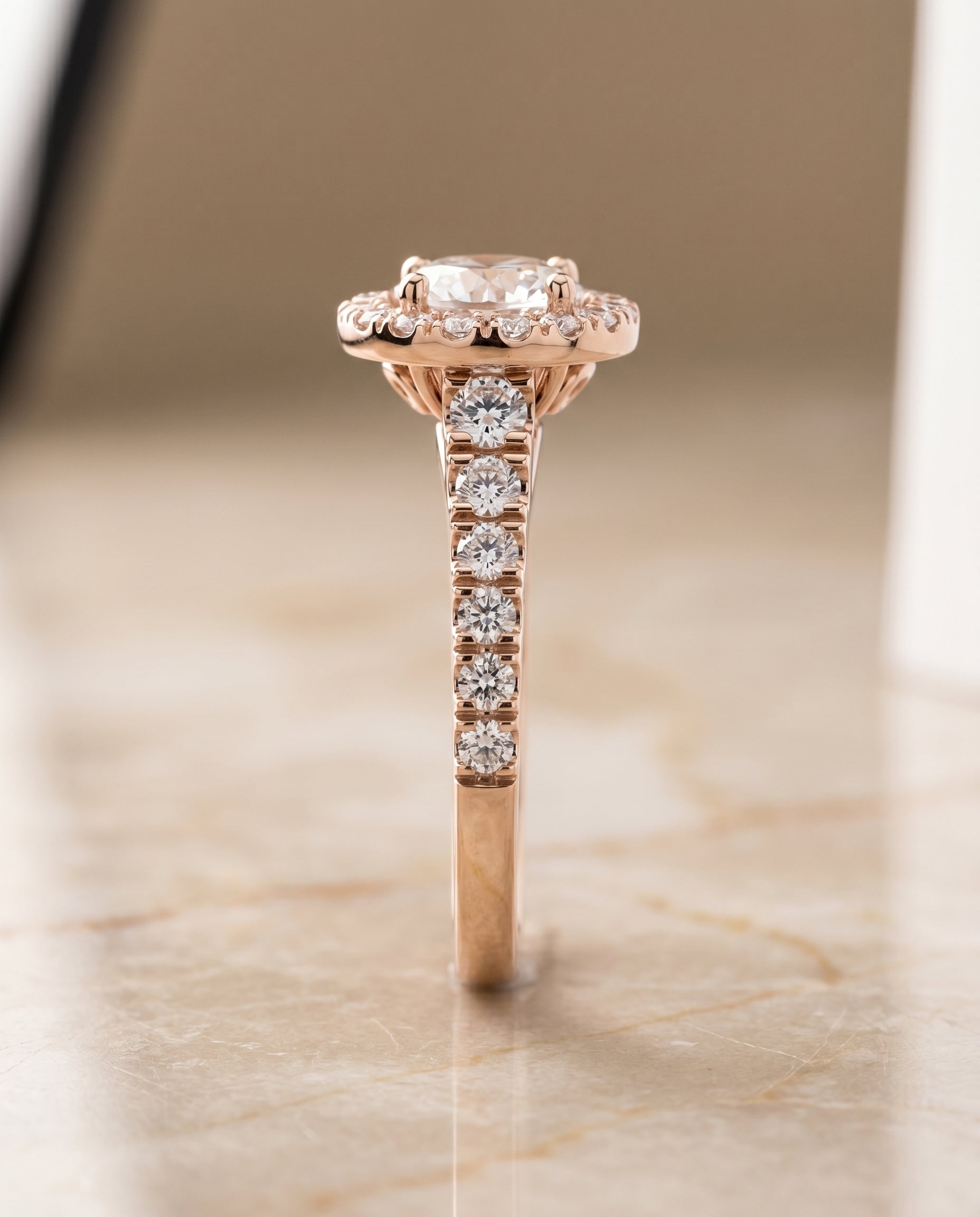 The Lucille shared prong halo linear side set engagement ring setting, shown in 14K Rose Gold | RockHer