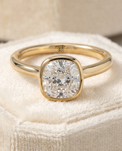 The Duran Simple Bezel Solitaire Cushion Cut Engagement Ring Setting in 18K Yellow Gold