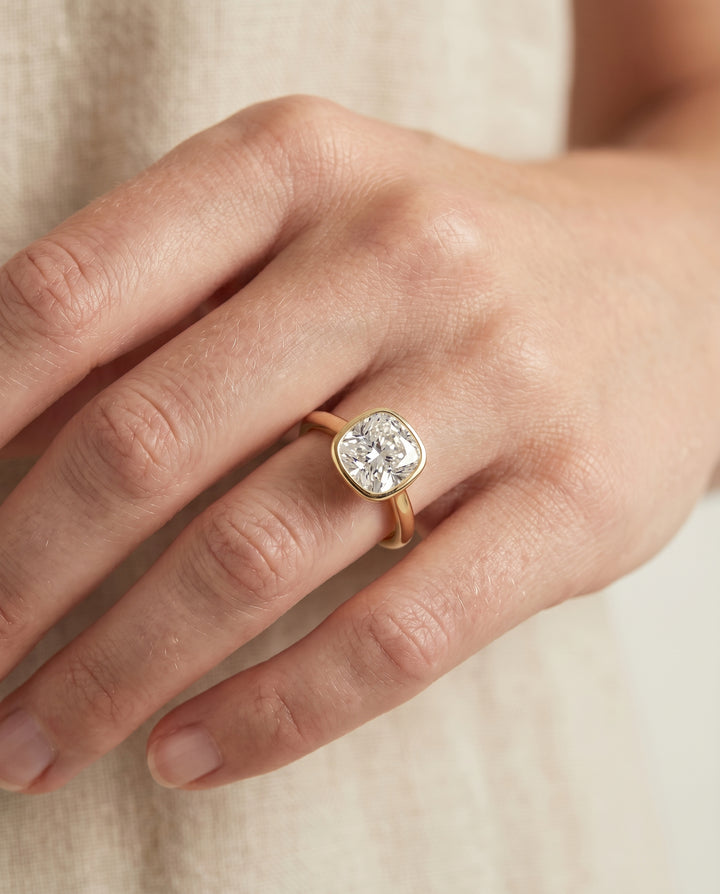 The Duran Bezel Solitaire Engagement Ring Setting for Cushion Diamonds in 18K Yellow Gold