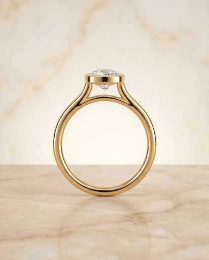 The Duran Simple Bezel Solitaire Cushion Cut Engagement Ring Setting in 18K Yellow Gold
