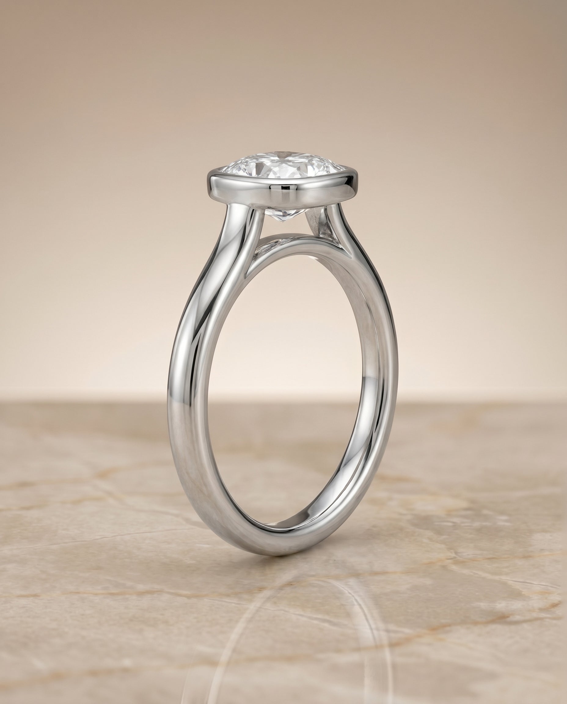 The Duran simple bezel solitaire cut engagement ring setting, shown in Platinum | RockHer