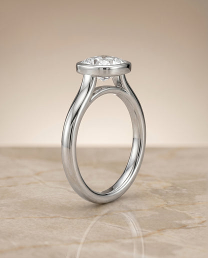 The Duran Simple Bezel Solitaire Cushion Cut Engagement Ring Setting in 18K White Gold