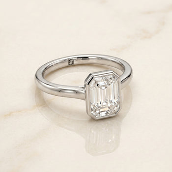 The Duran Simple Bezel Solitaire Emerald Cut Engagement Ring Setting in Platinum