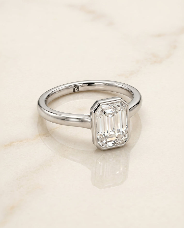 The Duran Select Simple Bezel Solitaire Emerald Cut Lab Diamond Engagement Ring in 18K White Gold