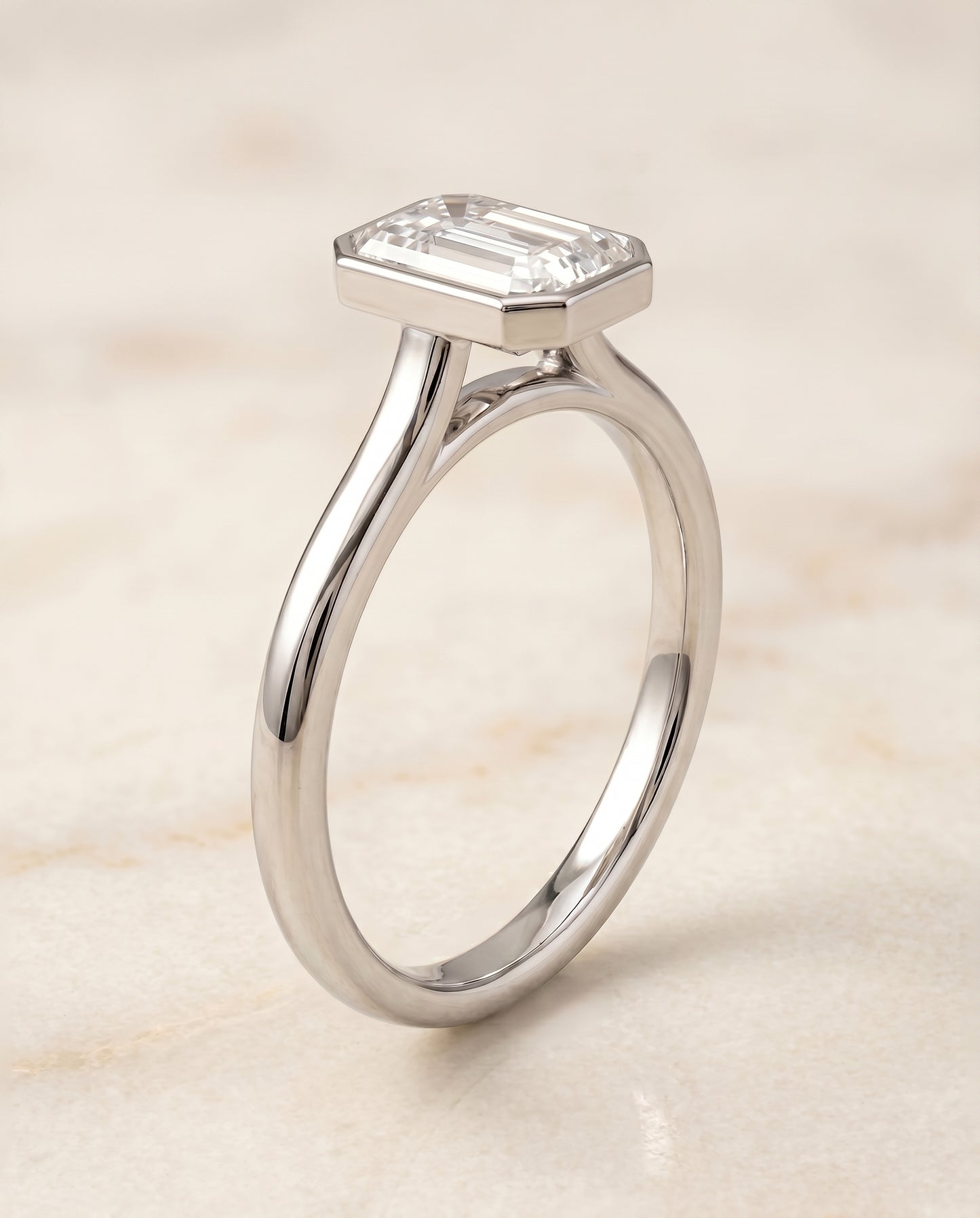 The Duran Bezel Solitaire Engagement Ring Setting for Emerald Cut Diamonds in 18K White Gold