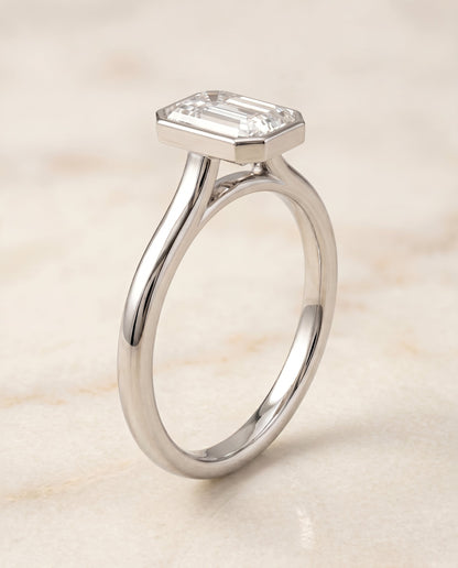 Duran Select Simple Bezel Solitaire Emerald Cut Lab Diamond Engagement Ring in 18K White Gold, front view | RockHer