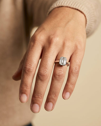 Duran Select Simple Bezel Solitaire Emerald Cut Lab Diamond Engagement Ring in Platinum, shown on hand | RockHer