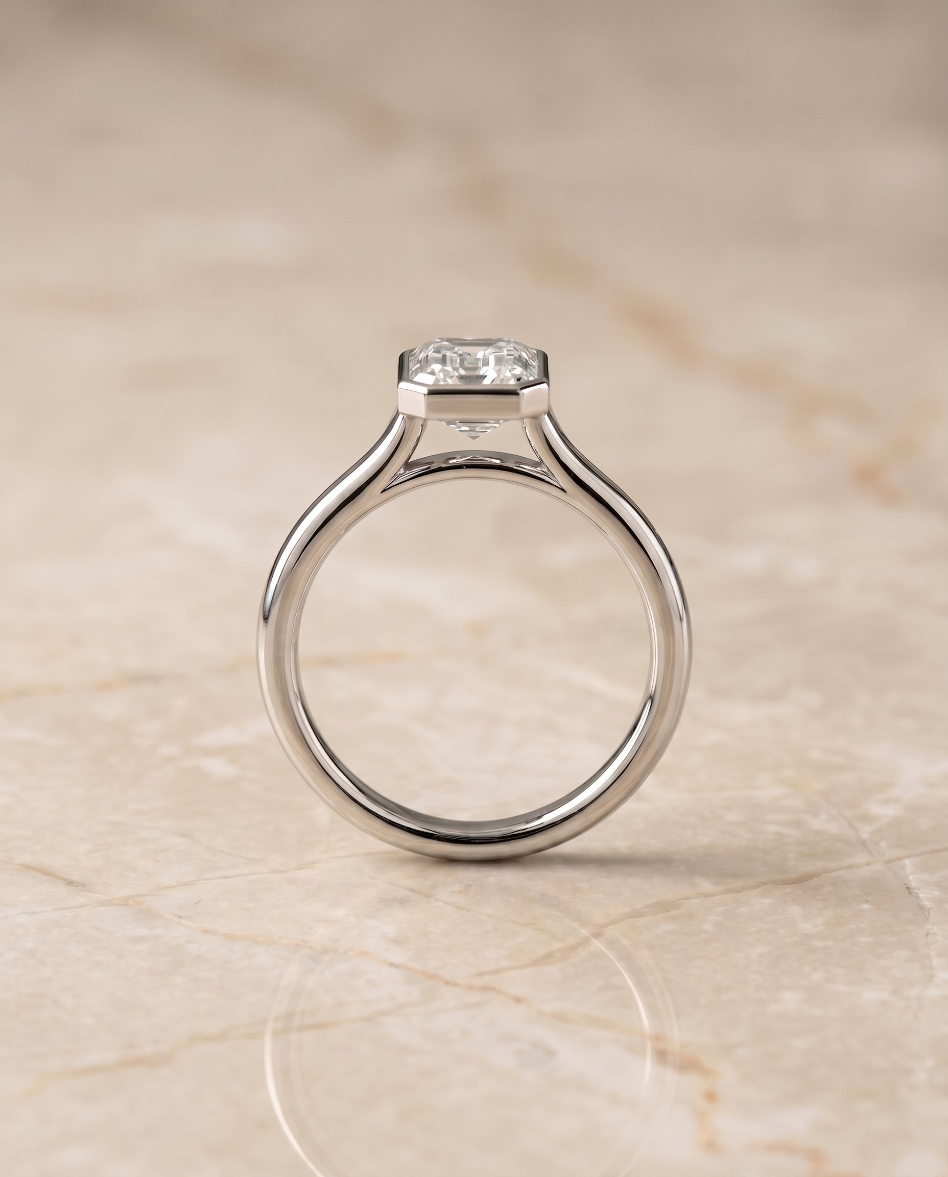 The Duran simple bezel solitaire cut engagement ring setting, shown in Platinum | RockHer