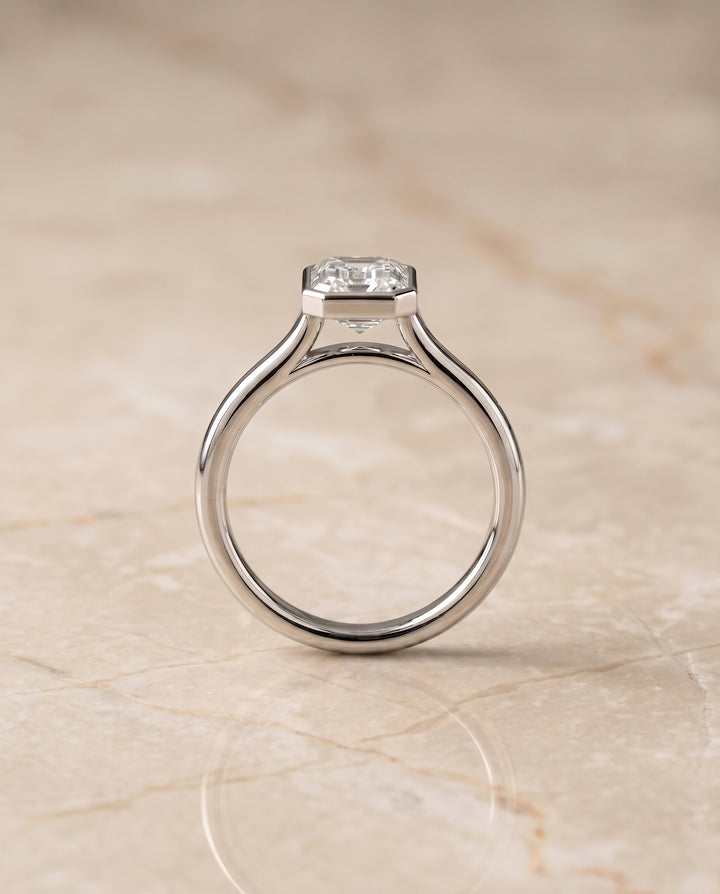 The Duran Bezel Solitaire Engagement Ring Setting for Emerald Cut Diamonds in 18K White Gold