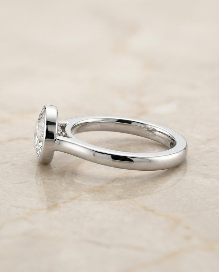 Duran Select Simple Bezel Solitaire Round Lab Diamond Engagement Ring in Platinum, side view | RockHer