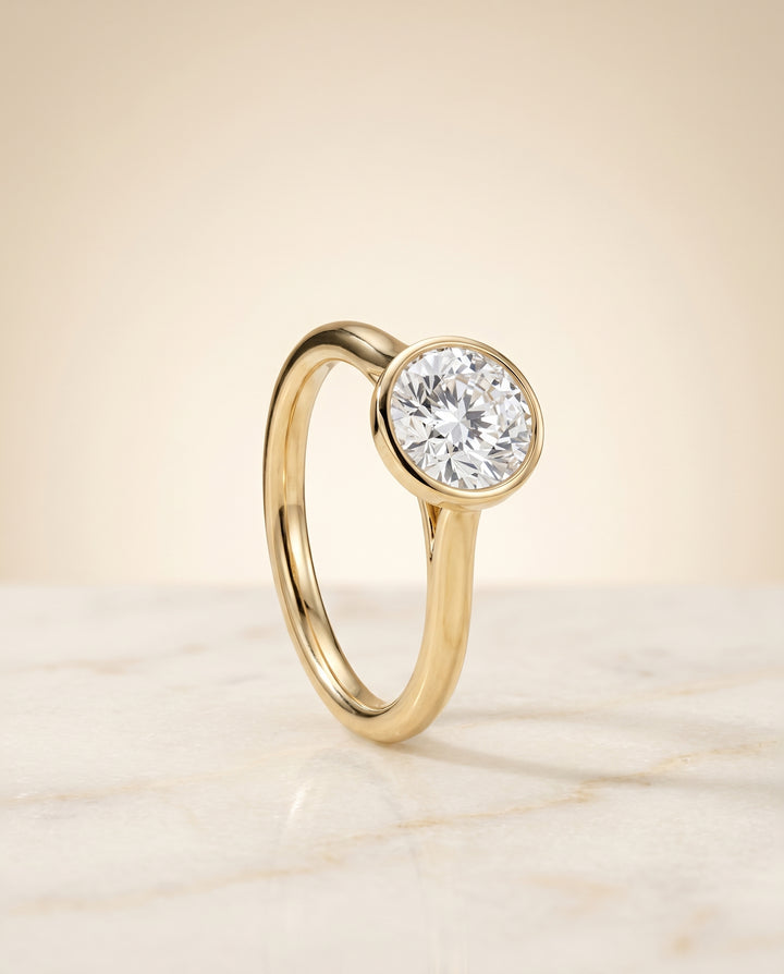 The Duran Bezel Solitaire Engagement Ring Setting for Round Diamonds in 18K Yellow Gold