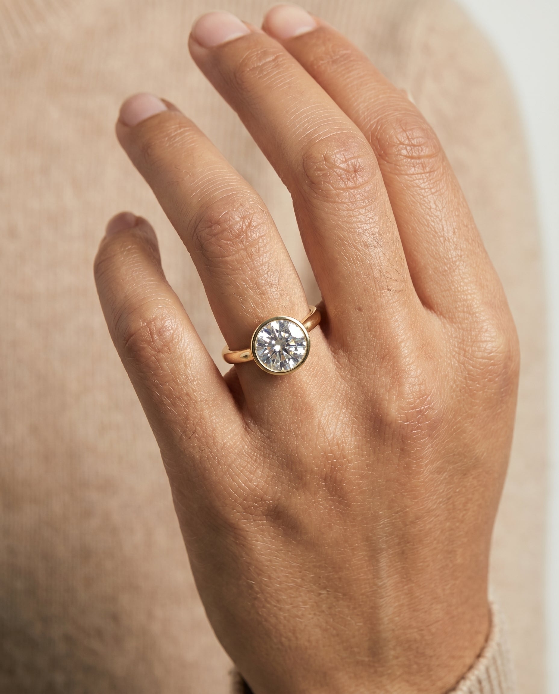 Duran Select Simple Bezel Solitaire Round Lab Diamond Engagement Ring in 18K Yellow Gold, shown on hand | RockHer
