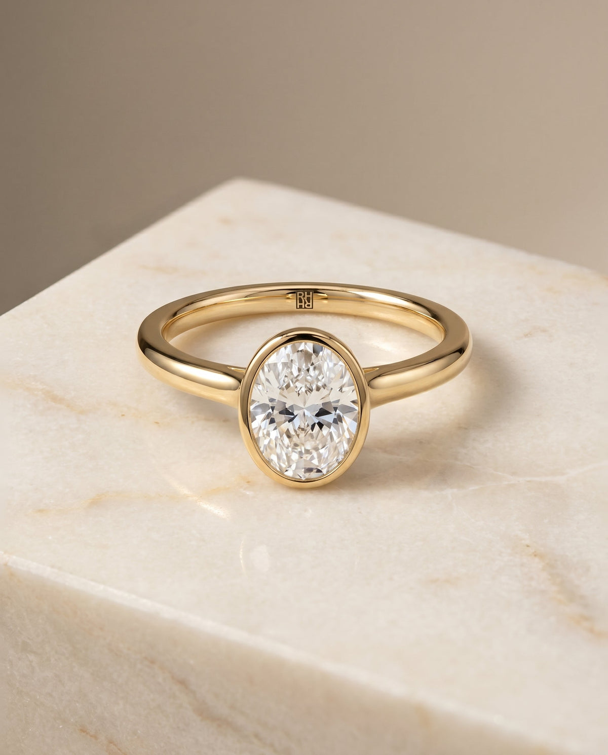 Duran Select Simple Bezel Solitaire Oval Lab Diamond Engagement Ring in 18K Yellow Gold, shown on hand, angled | RockHer