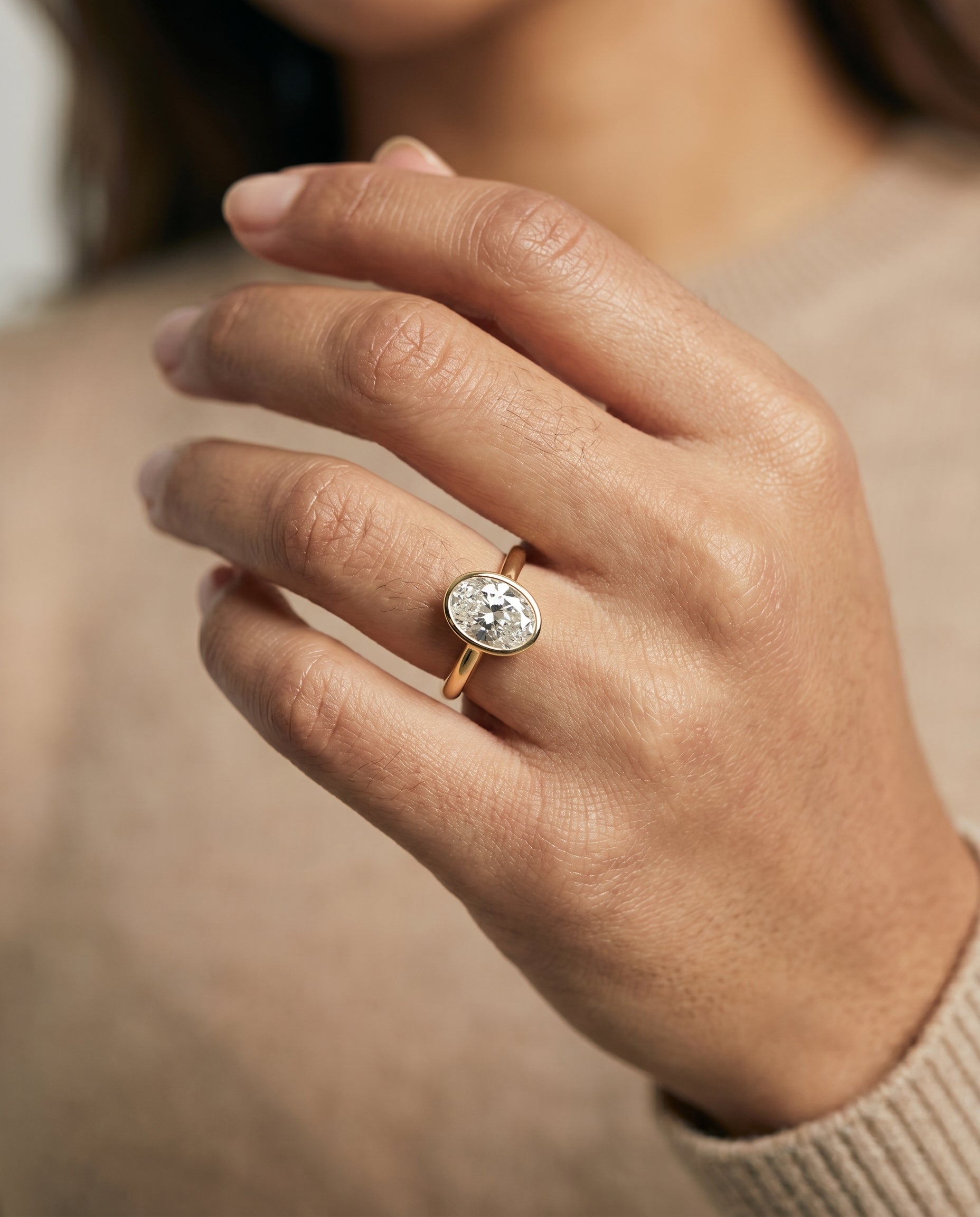 Duran Select Simple Bezel Solitaire Oval Lab Diamond Engagement Ring in 18K Yellow Gold, shown on hand | RockHer