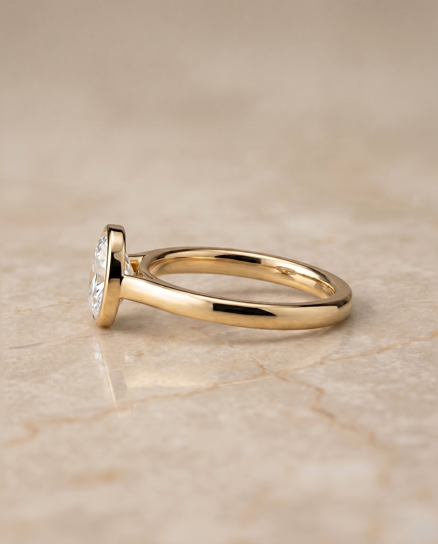 Duran Select Simple Bezel Solitaire Oval Lab Diamond Engagement Ring in 18K Yellow Gold, side view | RockHer