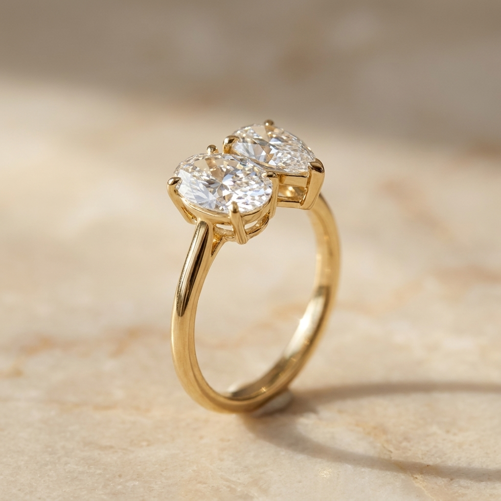 Solange Toi et Moi Oval & Pear Engagement Ring Setting - Alt angle on warm marble