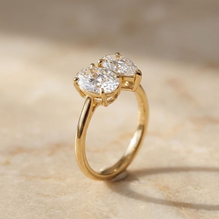 18K Yellow Gold Solange Toi et Moi Select Oval & Pear Lab Diamond Engagement Ring - Alt angle on warm marble