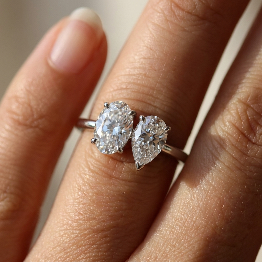Platinum Solange Toi et Moi Select Oval & Pear Lab Diamond Engagement Ring - Macro close-up on finger