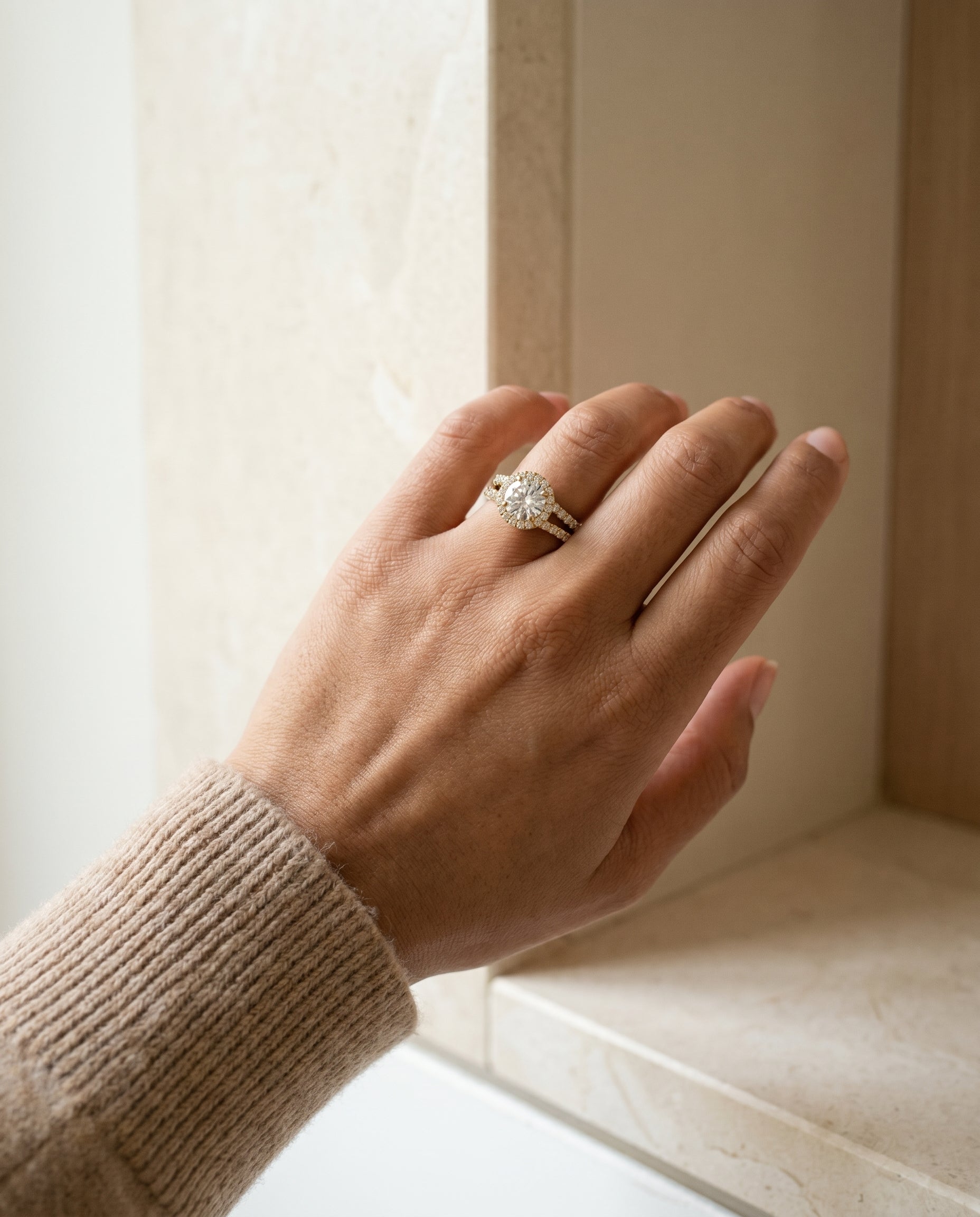 Nicki Select Split Shank Pavé Halo Round Lab Diamond Engagement Ring in 18K Yellow Gold, shown on hand, angled | RockHer