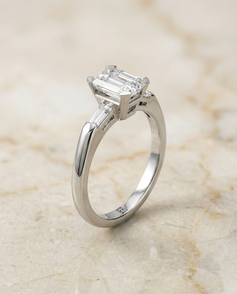The Caroline Three Stone Emerald Cut Engagement Ring Setting in 18K White Gold