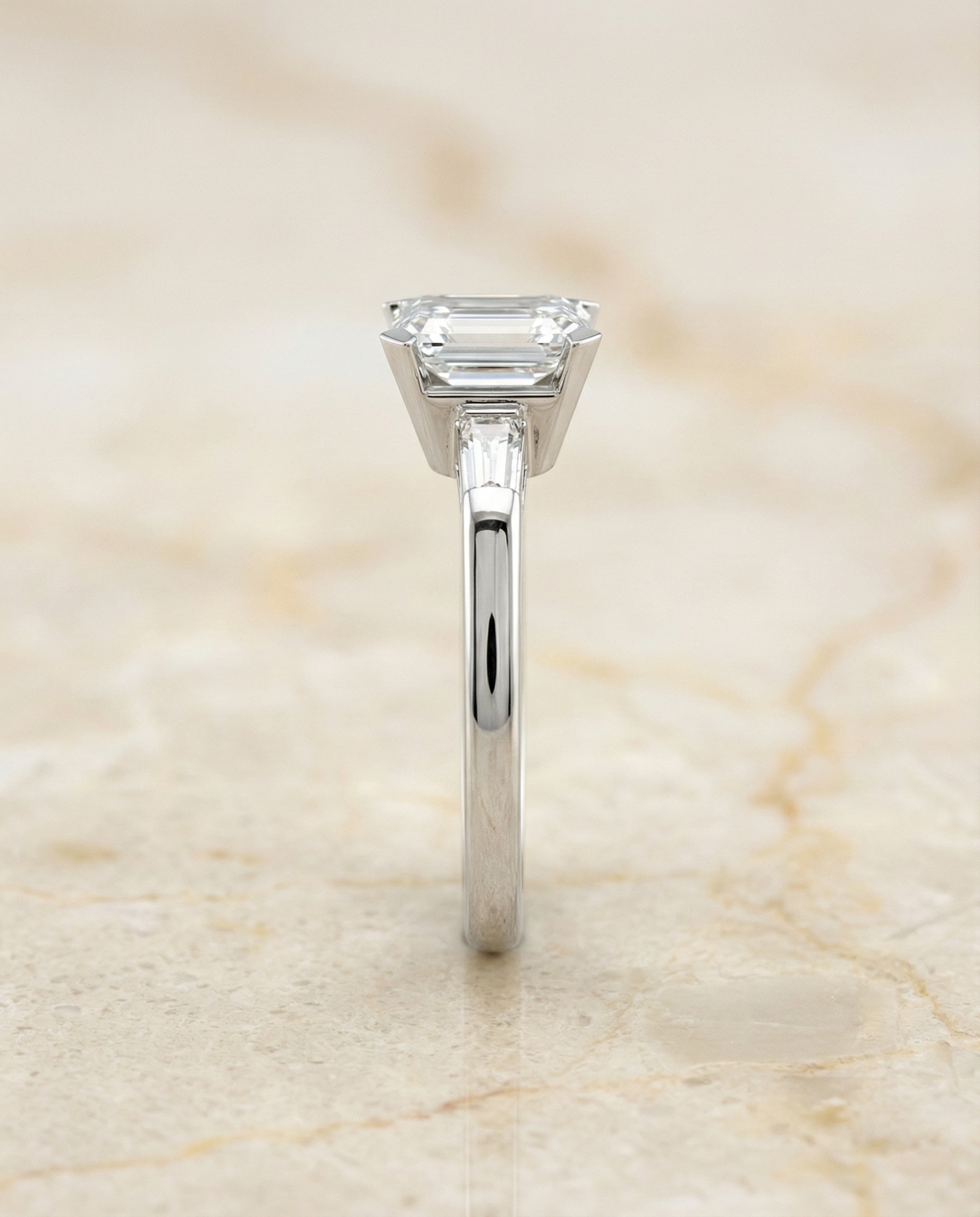 Caroline Select Three Stone Emerald Cut Lab Diamond Engagement Ring in Platinum, side view | RockHer