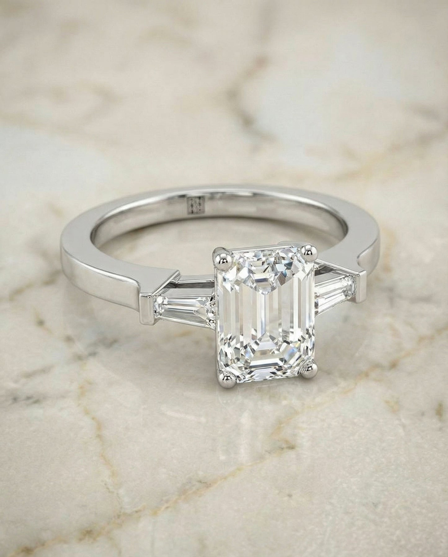 European Cut, Tapered Baguette Three Stone Emerald, in Platinum, channel setting – angled view | RockHer
