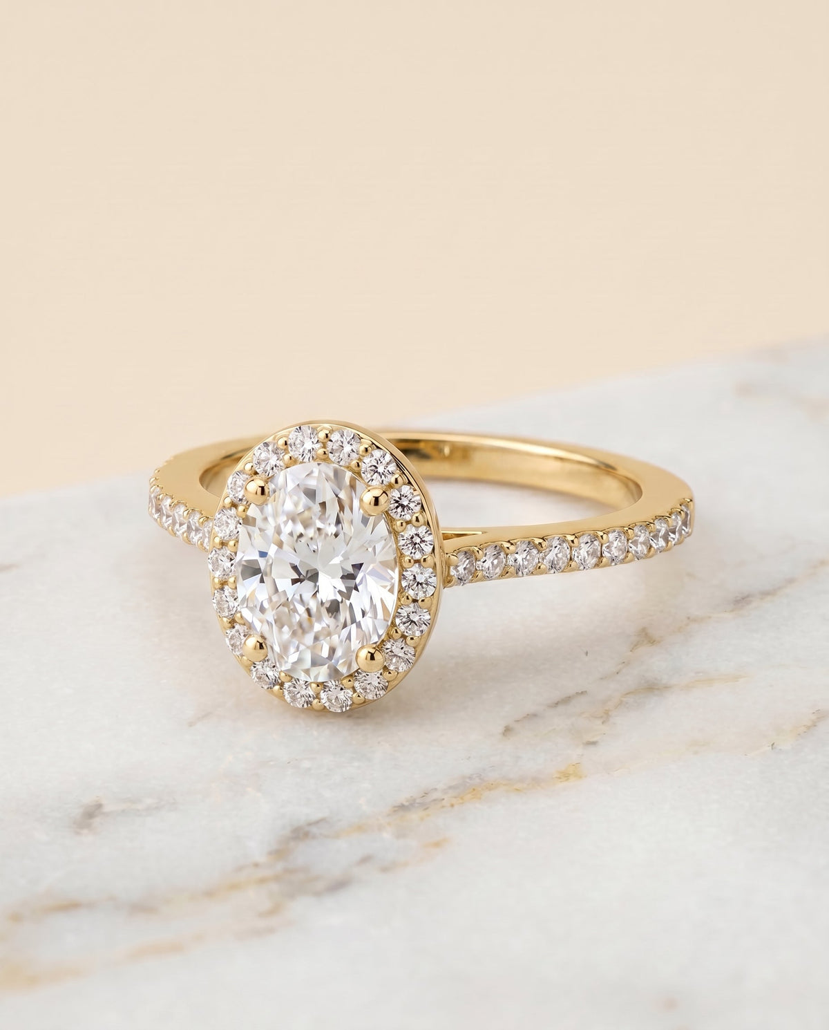 Taylor Select Pavé Halo Oval Lab Diamond Engagement Ring in 18K Yellow Gold, shown on hand, angled | RockHer