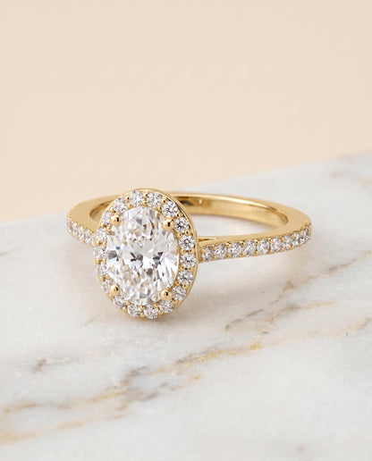 Taylor Select Pavé Halo Oval Lab Diamond Engagement Ring in 18K Yellow Gold, shown on hand, angled | RockHer
