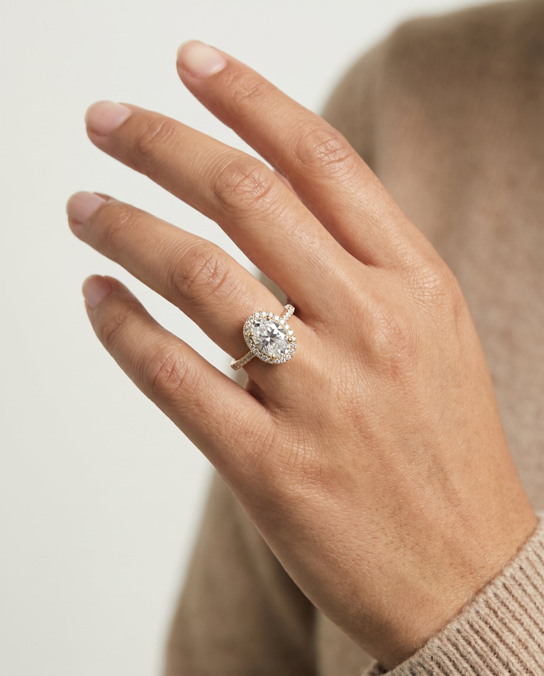 Taylor Select Pavé Halo Oval Lab Diamond Engagement Ring in 18K Yellow Gold, shown on hand | RockHer