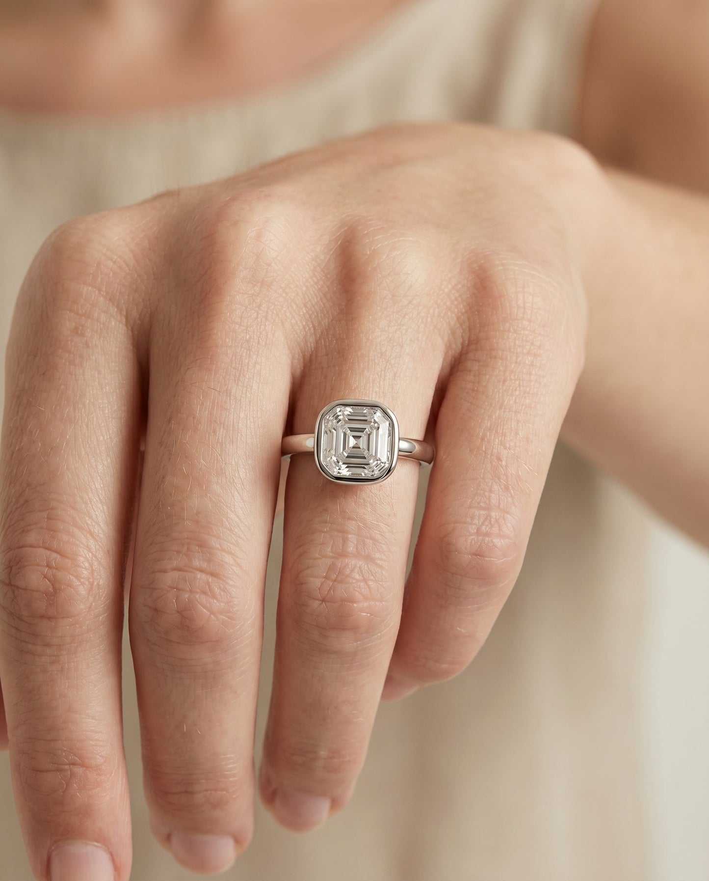 Agnes Select Bezel Solitaire In Asscher Cut Lab Diamond Engagement Ring in Platinum, shown on hand | RockHer