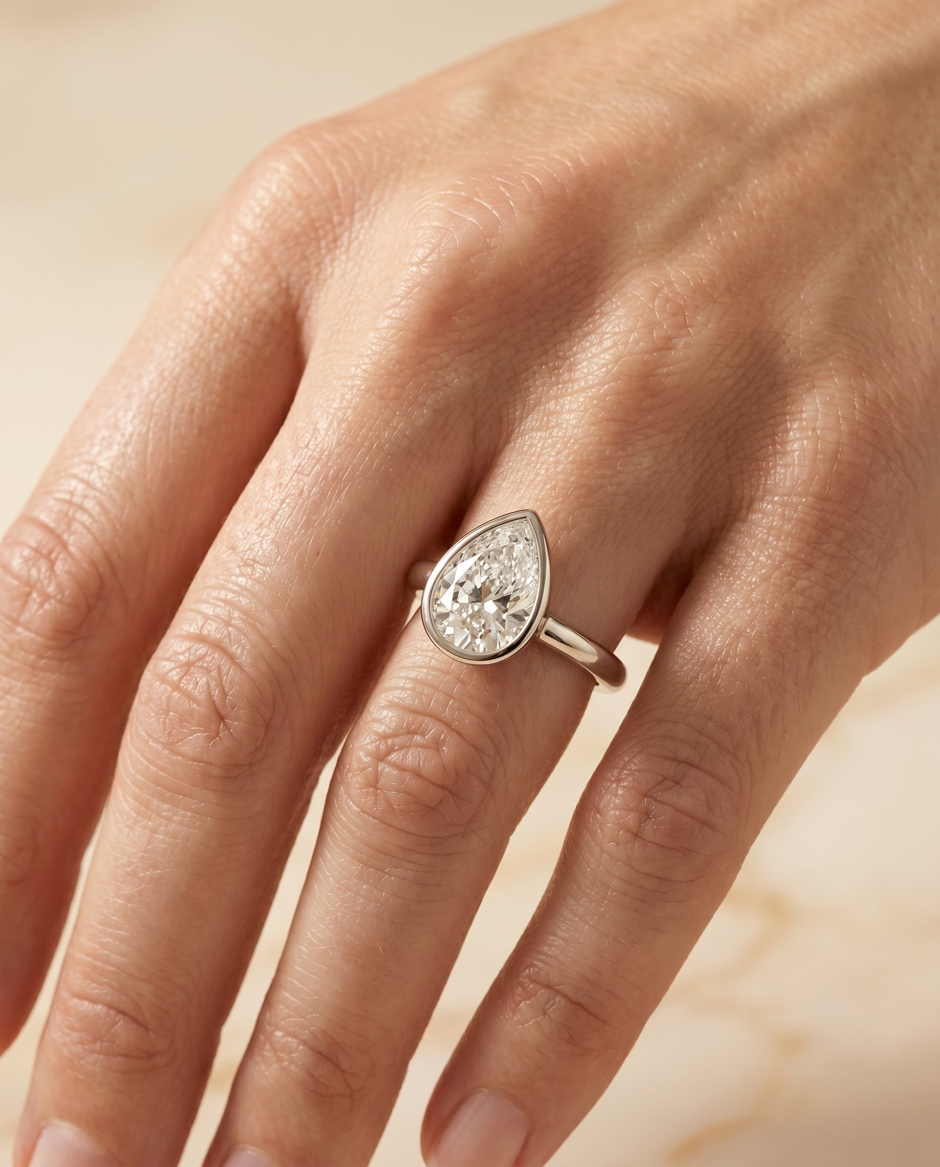 The Agnes engagement ring setting in 18K White Gold, bezel solitaire in briolette design | RockHer