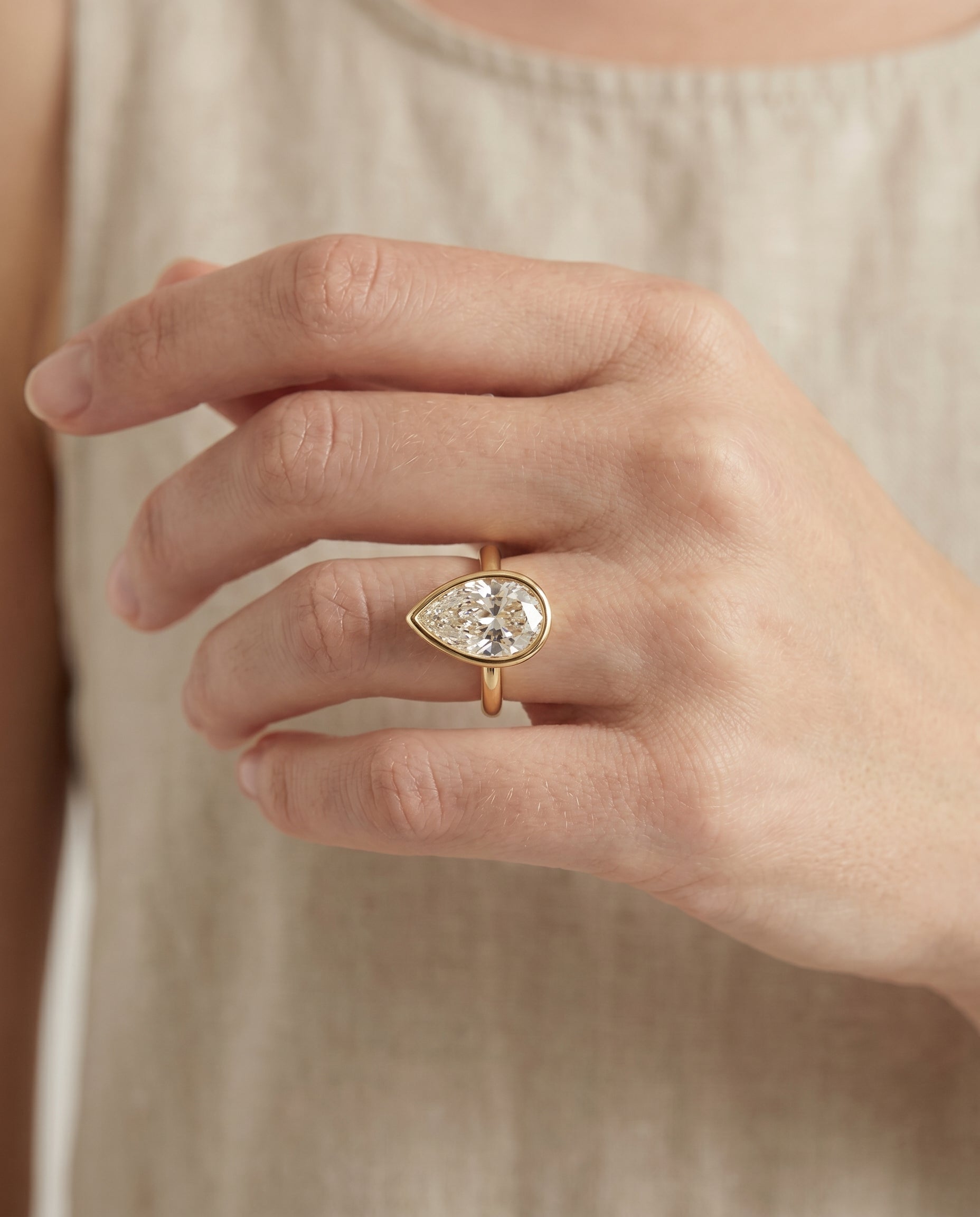 The Agnes engagement ring setting in 18K Yellow Gold, bezel solitaire in briolette design | RockHer